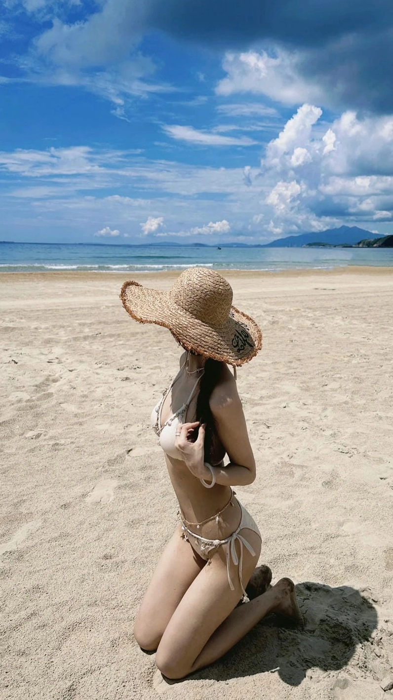 Ảnh gái xinh bãi biển tựa lưng vào cây dừa, thần thái sang chảnh