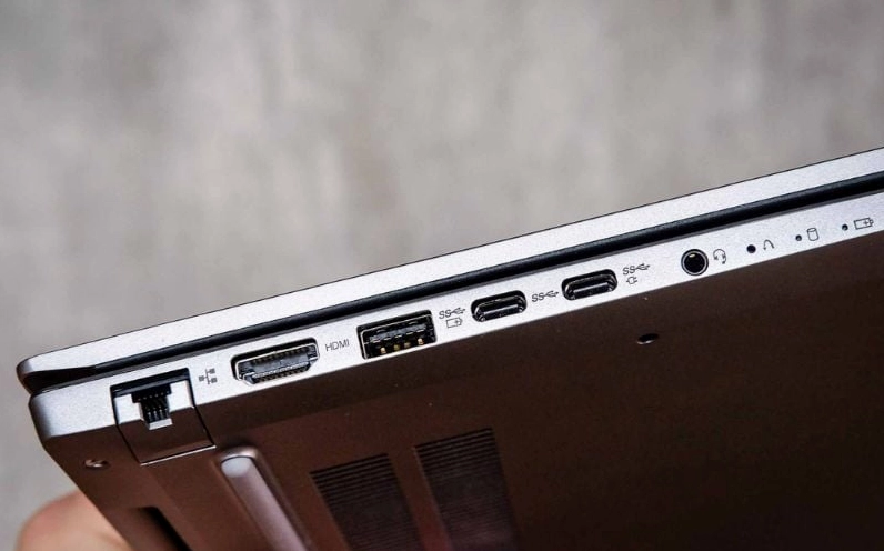 Hướng dẫn chi tiết cách cài đặt laptop mới mua chuẩn kỹ thuật 2 Người dùng đang kiểm tra các cổng kết nối ở cạnh bên của laptop